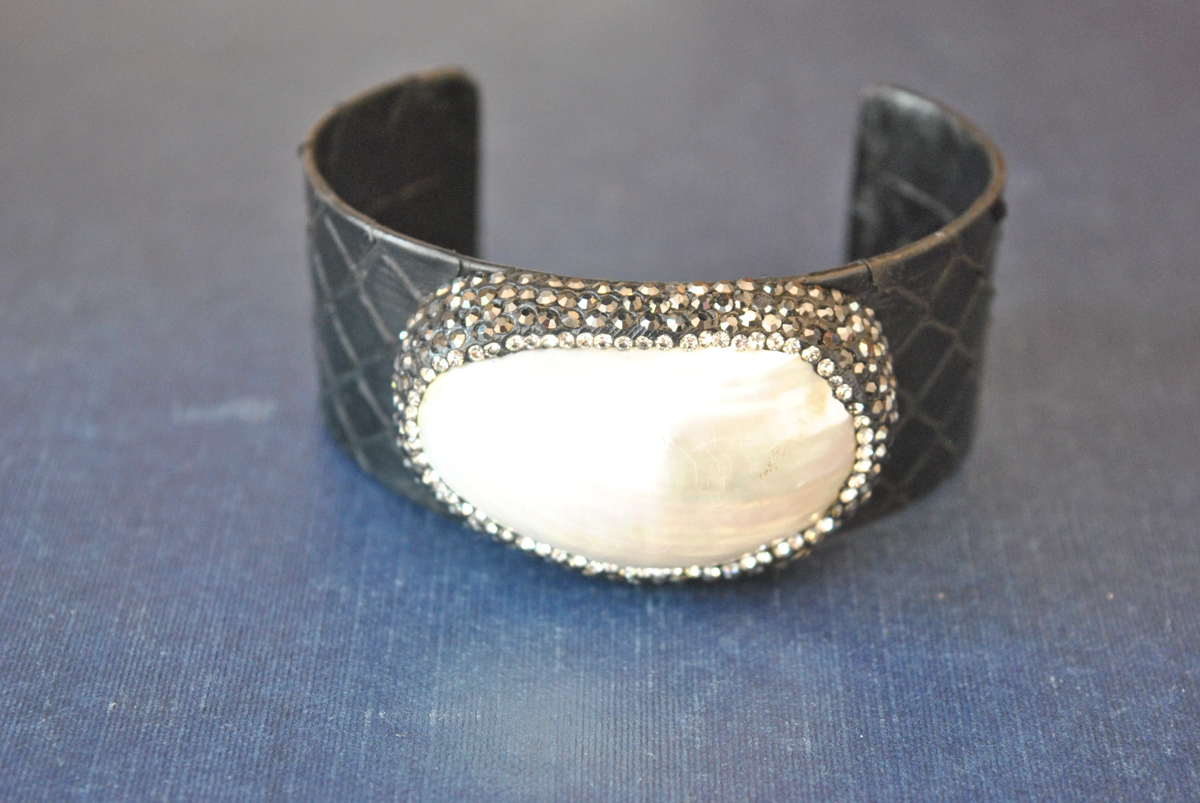 BLACK ECO LEATHER CUFF WITH WHITE SHELL AND SWAROVSKI CRYSTALS
